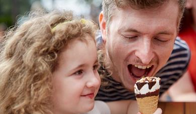 Father and daughter eating ice creaam.