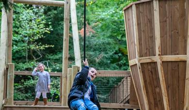 Young child on an aerial slide