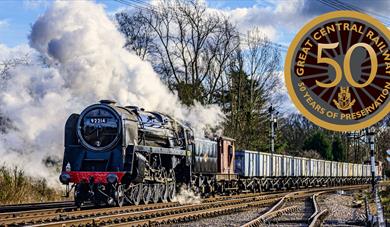 A steam train on the Great Central Railway with 50th anniversary logo