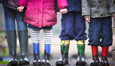 Four kids with muddy boots