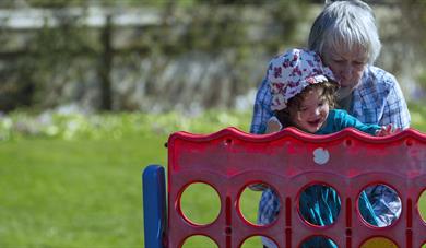 Grandmother with curious and happy young child