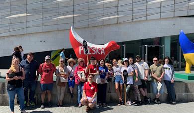 A group pose beside a superlambanana in Liverpool.