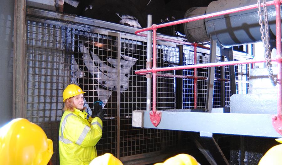 Visitors in high-vis inside a Mersey tunnel.