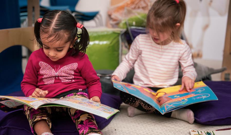 Two children reading books.