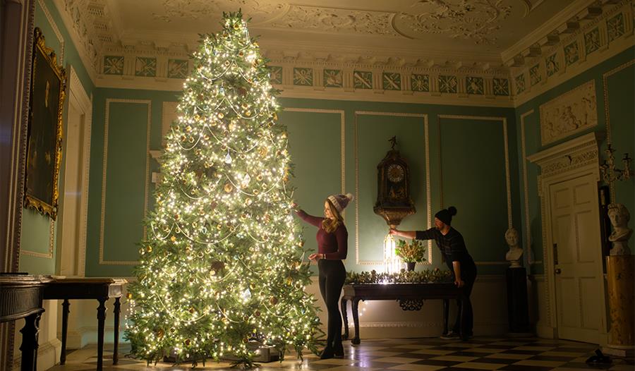 people decorating a tree at Saltram