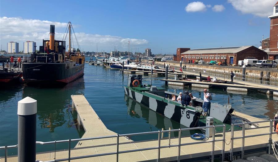 People on a boat at a Pontoon Open Day outside Boathouse 4