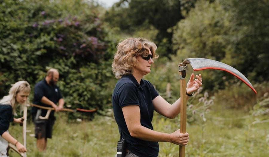 Person stood holding a scythe