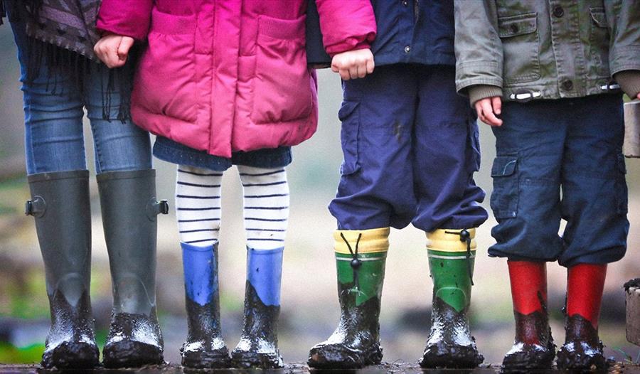 Four kids with muddy boots