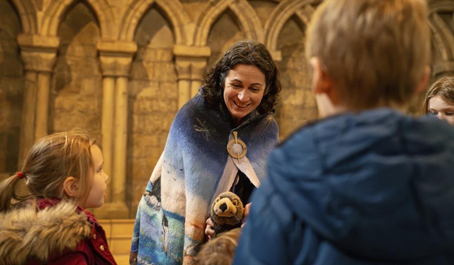 Elizabeth Baker, local storyteller and writer, entertaining children at Durham Cathedral with thought-provoking tales.