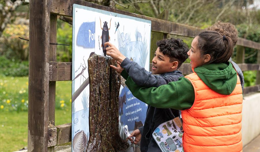 children pointing at trail boards