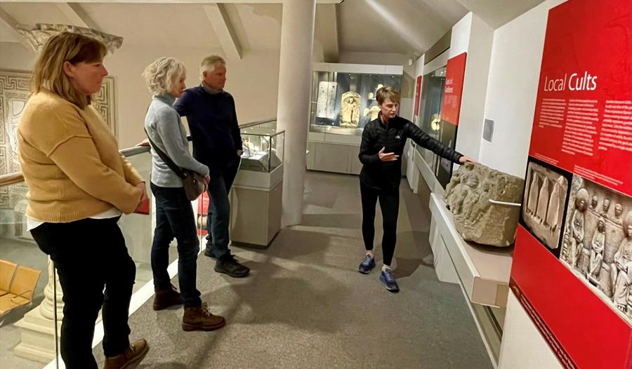 A tour leader explaining about museum exhibits