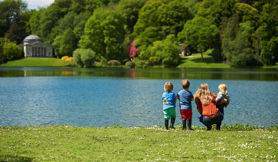A family looking out over the lake and Pantheon in the distance at Stourhead