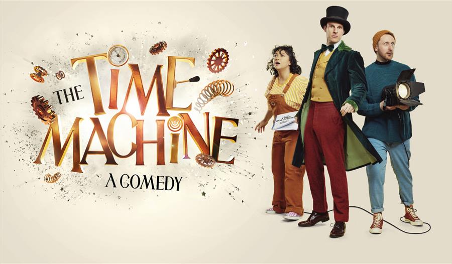 Three people stood in a V formation next to the words 'The Time Machine - a comedy'