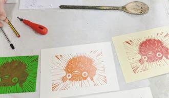 Lino prints of pufferfish in red and orange
