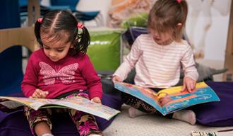 Two children reading books.