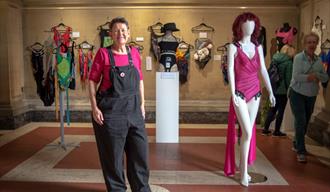 Artist Amanda Hall standing next to her piece during an exhibition