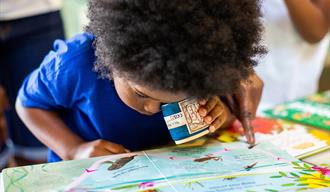 child closely examines picture map