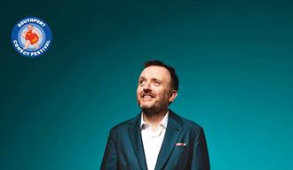 Comedian Chris McCausland smiling  promo image for his show at the Southport Comedy Festival