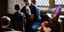 halloween image of man petting owl with children watching