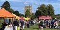 Villagers and visitors enjoying a sunny fete