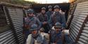 A group of men in blue First World War French uniforms stand inside a trench system at Verdun, where the battle took place in the First World War