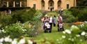 the gradens of National Trust Nostell. a group of people walking in the garden amongst the flowers