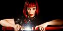 Republica singer Saffron pulls a sword out of it scabbard