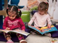 Two children reading books.
