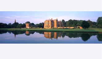 reflections of broughton castle at dusk
