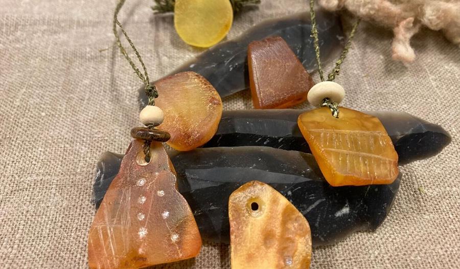 a range of amber pendants polished and engraved