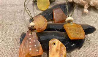 a range of amber pendants polished and engraved