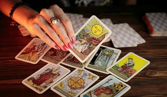 Hand holding colourful tarot cards