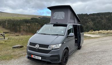 VW campervan set up at a sulby reservoir on the Isle of Man with the pop-top roof raised