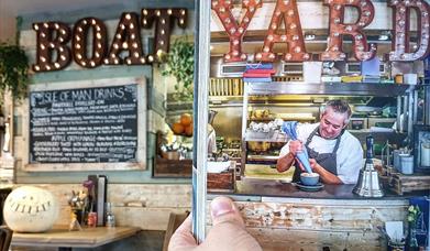 Picture shows a chef preparing dessert in the open hatch of the kitchen
