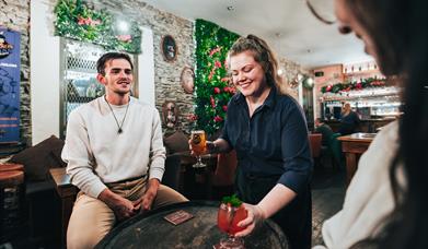 Couple being served drinks