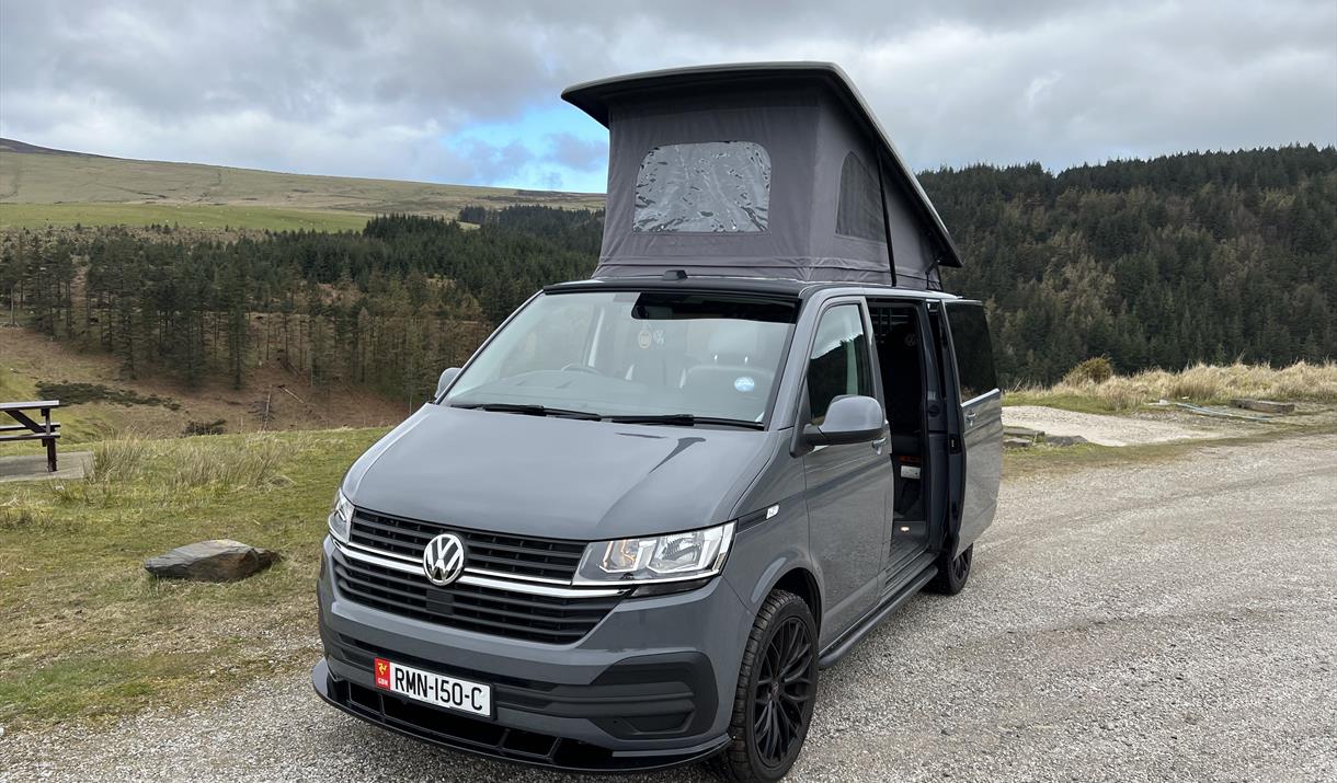 VW campervan set up at a sulby reservoir on the Isle of Man with the pop-top roof raised