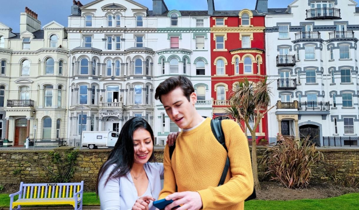 Couple playing Go Quest Adventures on the Douglas promenade.