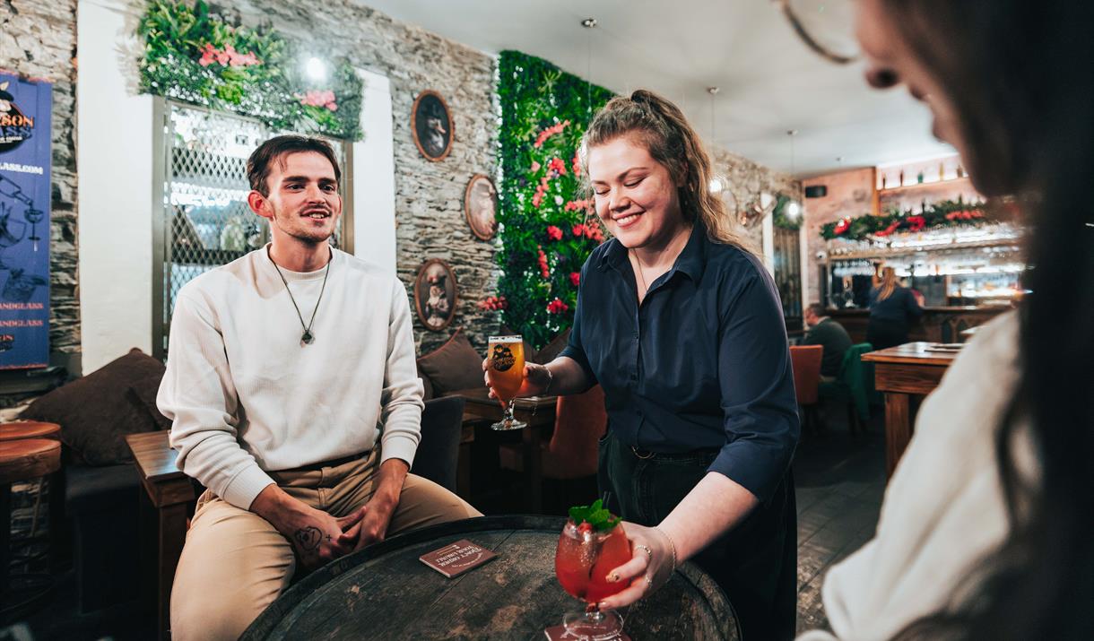 Couple being served drinks