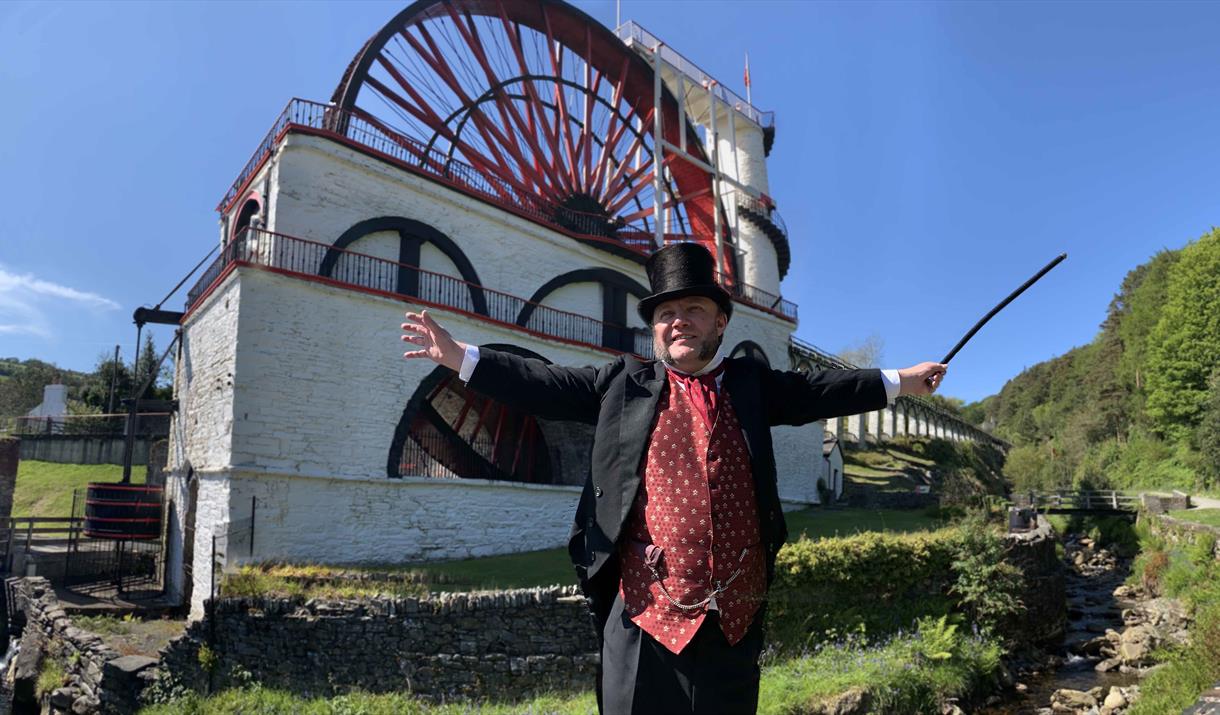 Mine Captain Rowe narrates a video greeting in the Welcome Centre, Christ Church, Laxey. Costume volunteers greet visitors in the Welcome Centre.