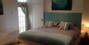 Chapel Bay Lodge bedroom with super king sized bed.  This can be converted into two singles if required, please advise when booking