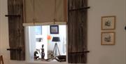 View through from bedroom to lounge in Chapel Bay Lodge