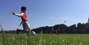 Child kicking a rugby ball