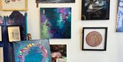 Inside Pink Seaweed gallery showcasing artwork by Vici Blackburn, Leanne Higgins, Greg Barlow and Mike Radcliffe, surrounded by handmade Manx treasure