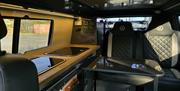 Inside the campervan, sat in the front looking at the rear