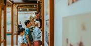 A family group reading information boards.