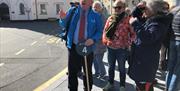 Wild Mann Tours guiding cruise ship visitors in Castletown.