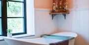 Ensuite wet room featuring free standing bath & also walk in shower