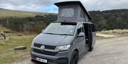 VW campervan set up at a sulby reservoir on the Isle of Man with the pop-top roof raised