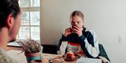 Couple enjoying coffee and pastries