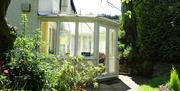 Entrance through conservatory.